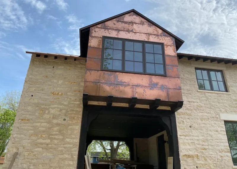 Copper metal panel facade on a stone building for Metal Roof Coating in North Fort Lewis